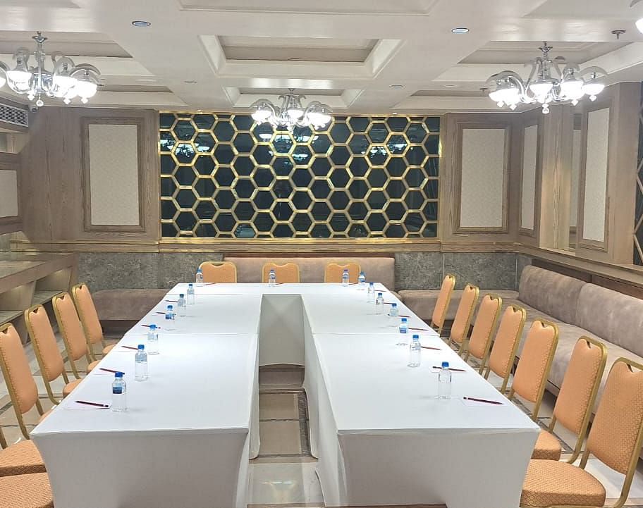 An event space with chairs arranged on both sides and tables placed in the middle at BluSalzz Residence, Amritsar